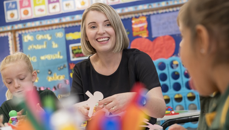 Winning teacher in classroom with her students